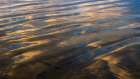 USA, New Jersey, Cape May National Seashore. Sunrise reflections on shore water and sand. Art Print